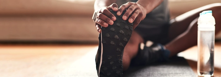 Chiropractic Coral Springs FL Stretching Person A person stretching their leg.