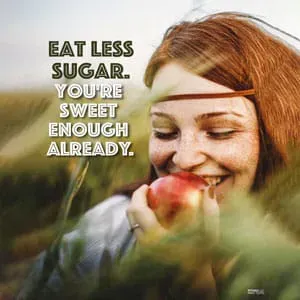 red-haired woman with an apple in her hand, smiling and enjoying.