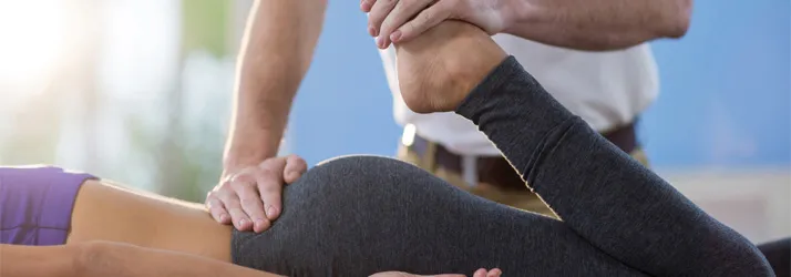 Chiropractic Coral Springs FL Personal Injury A woman lying face down, where we can see that her leg is being stretched.